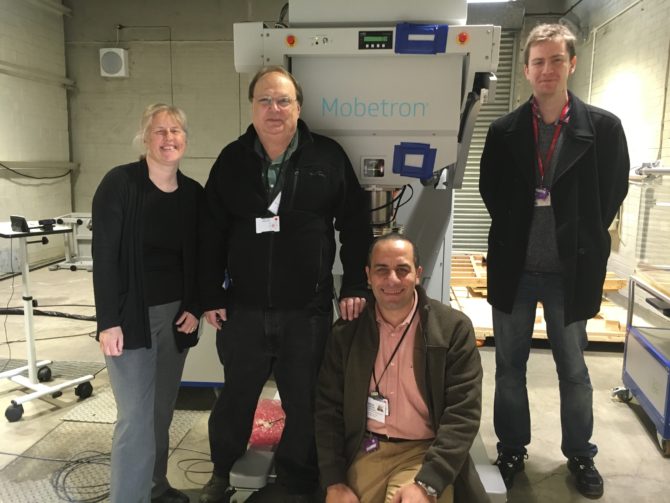 PLANETS Cancer Charity crew poses in front of IntraOp Mobetron
